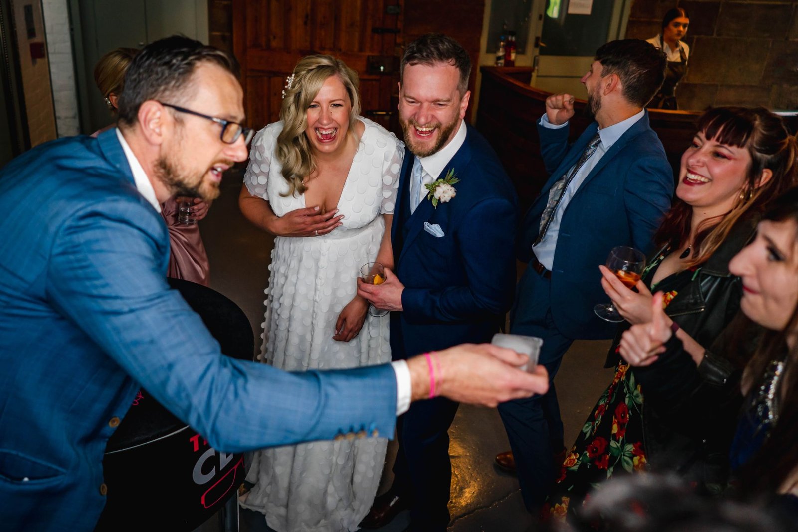Wedding magician Close-Up Chris performing close-up magic for a bride and groom and their guests